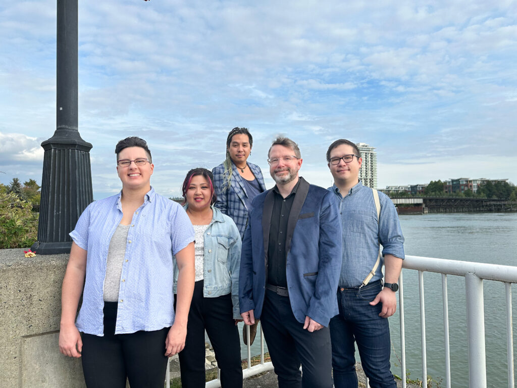 The cast of Quayside Voices stands in New Westmisnter's Pier Park overlooking the Fraser River.