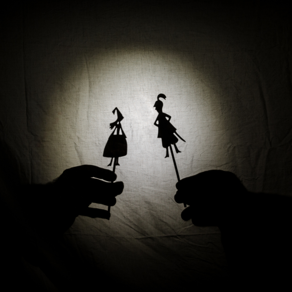 A Princess shadow and a knight shadow face each other within a spotlight